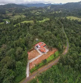 Aerial view of The GreenStay surrounded by Western Ghats forest