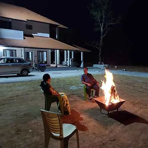 Guests by the bonfire at night